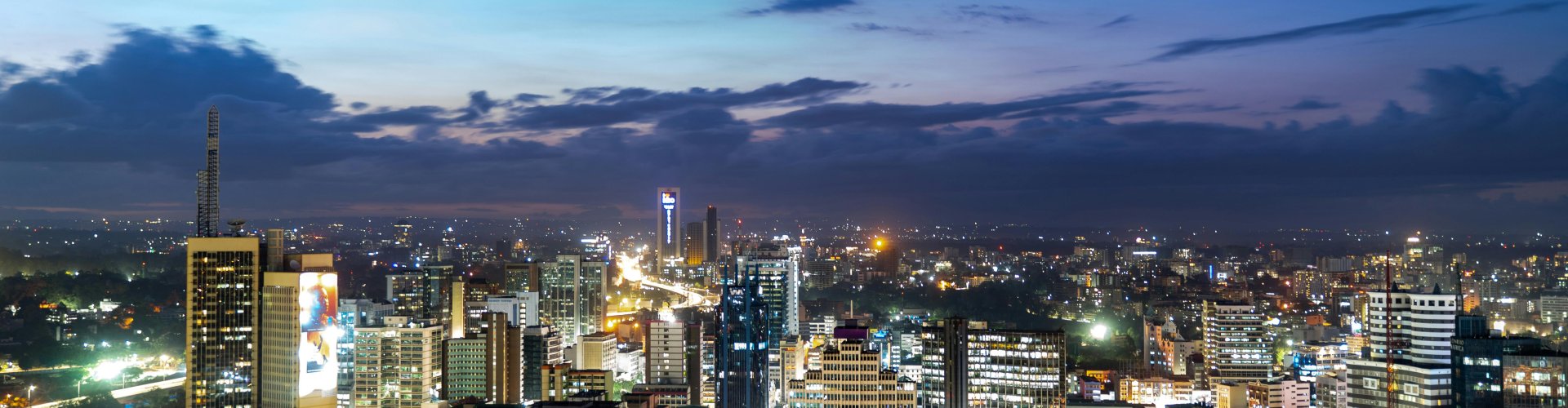 Nairobi night skyline with parked cars