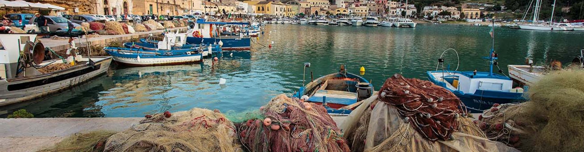 Night skyline of Castellammare del Golfo with parked cars