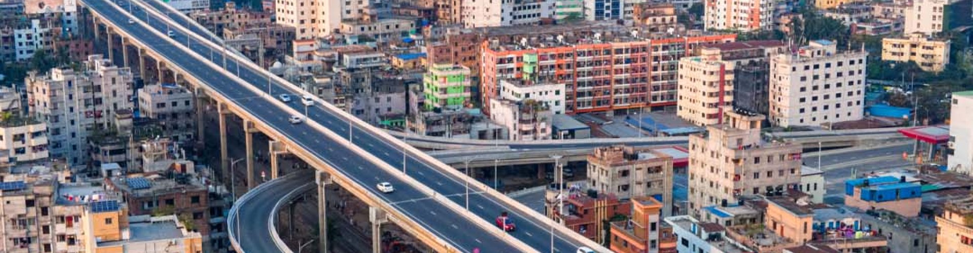 Dhaka night skyline with parked cars