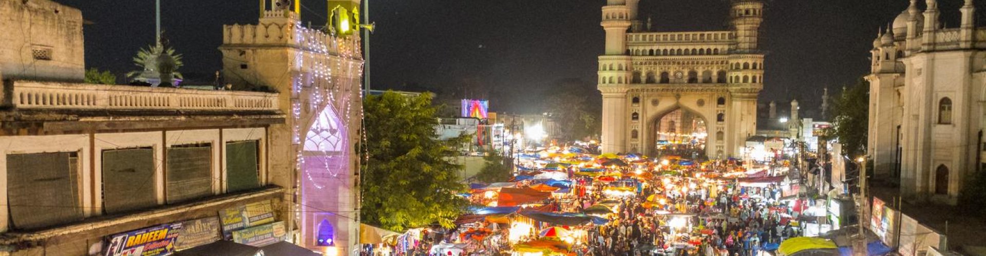 Hyderabad night skyline with parked cars