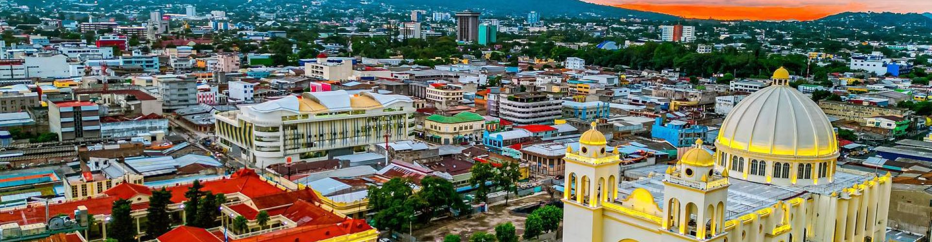 San Salvador night skyline with parked cars