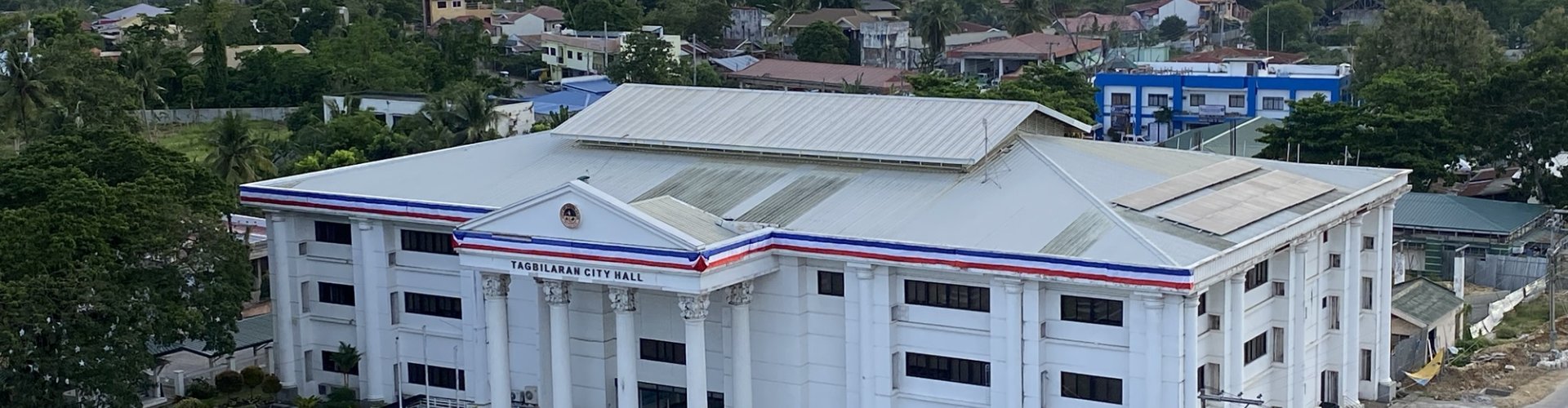 Tagbilaran City night skyline with parked cars