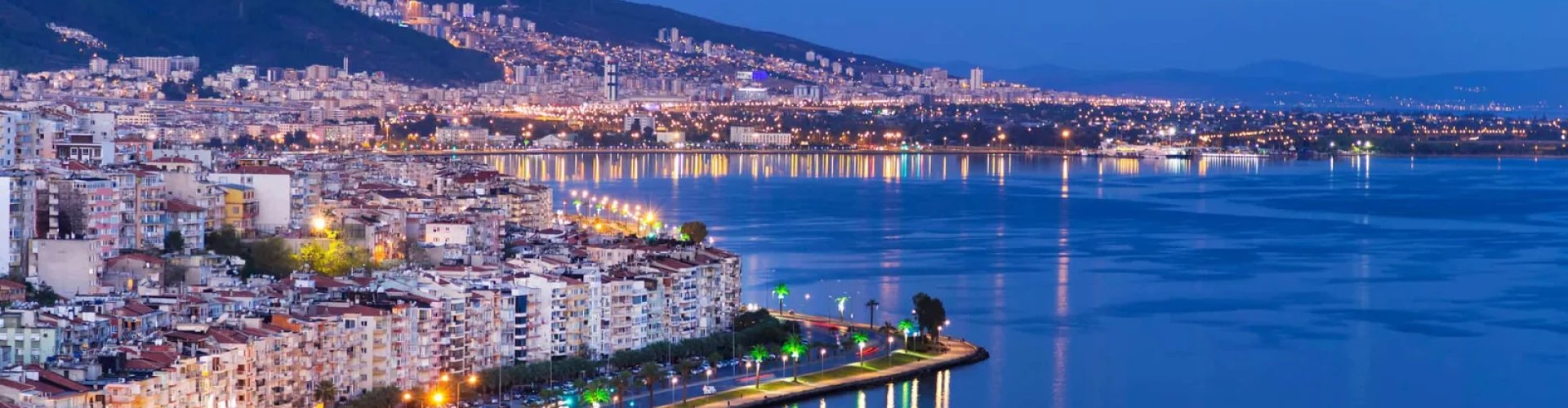 Izmir night skyline with parked cars
