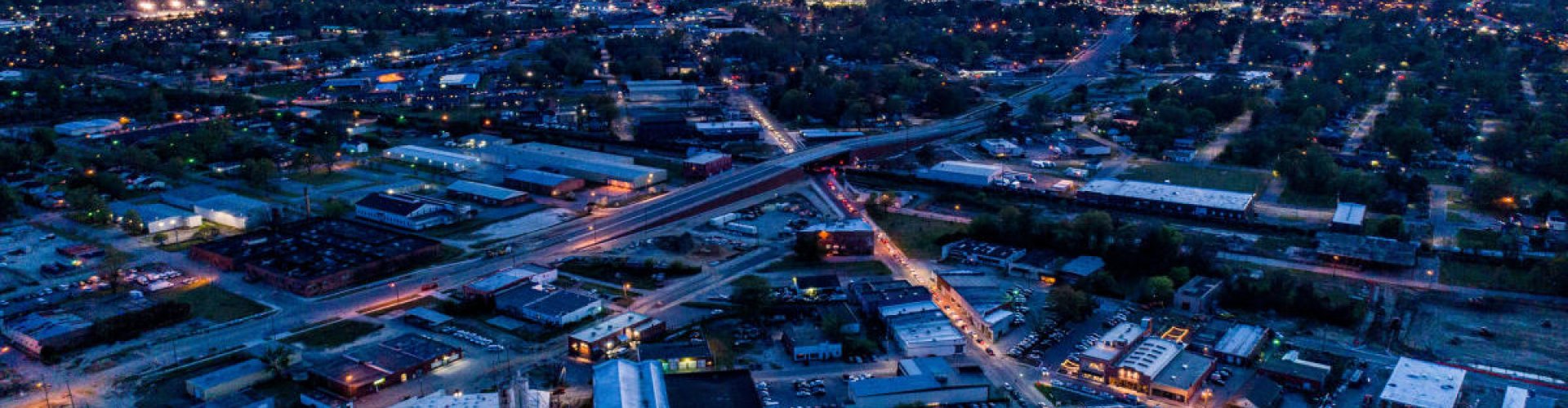 Greenville night skyline with parked cars